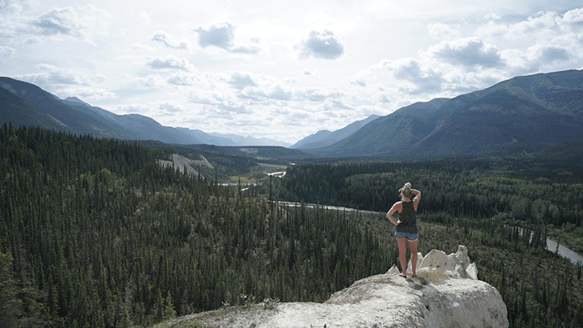 person looking out over river valley