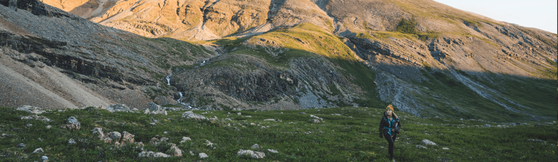 person hiking near mountain