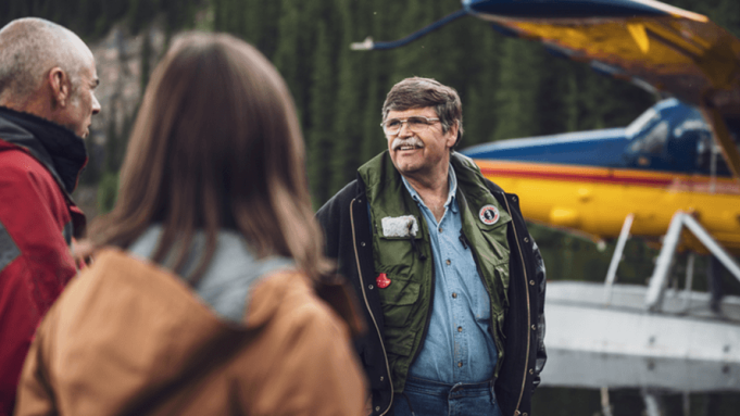 operator with two people in front of plane